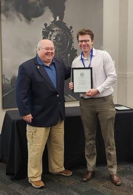 A researcher is presented with an award